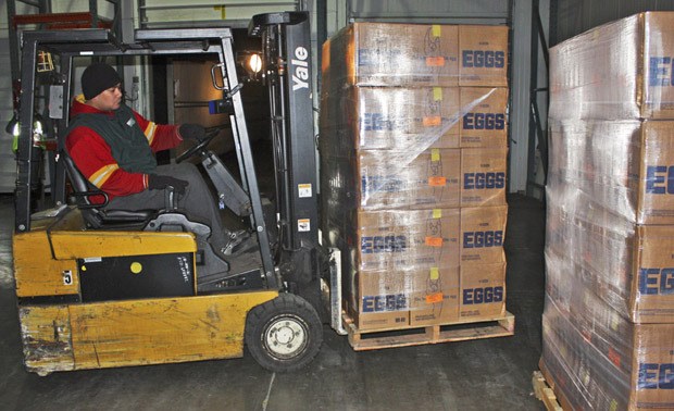 Northwest Harvet's Fiti Mua unloads pallets of fresh eggs into the Northwest Harvest Kent Warehouse.
