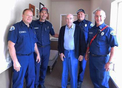 A group of Kent Fire Department officials visit Aegis of Kent resident Jack Murrey