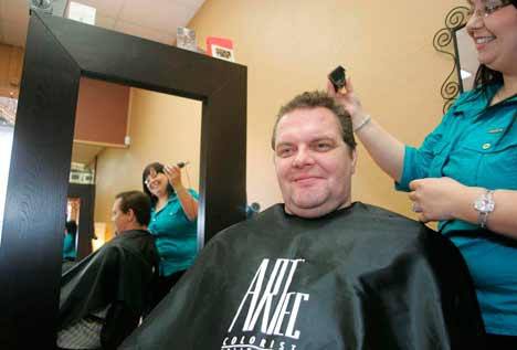 Wade Schwartz gets a hair cut from Stylist Shelby Miller at Downtown Kent's Blanc N Schwartz Salon Jan. 6. Schwartz is the owner of the Downtown Kent salon.