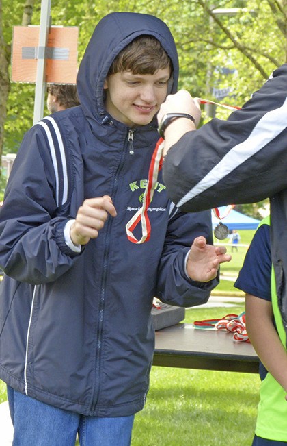 Michael Jorski picks up his silver medal for his soccer skills at the King County Region Soccer Tournament.