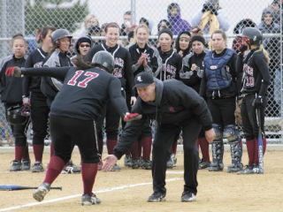 Kentlake coach Greg Kaas greets Felecia Harris at home plate after Harris homered in last Friday’s 5-2 win against Kentwood.