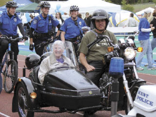 Cancer survivor Myrtle Davidson rides in a sidecar as a guest of honor during the opening ceremony at last year’s Relay for Life of Kent. Her driver is Randy Dahl