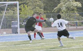 Kentlake’s Alex Ng (14) steps back after letting fly with a shot that gets past the outstretched hand of Jefferson goalkeeper Brian Bosshart and defender Nick McNew for the Falcons’ second goal of last Friday’s game against Jefferson. The teams played to a 2-2 tie.