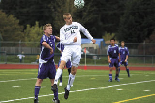 Kentwood’s Conner Biggs goes up for a header in front of Tahoma’s Tyson Elis during last Saturday’s district playoff game. The Conquerors qualified for state with a 3-1 victory