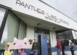 Students and parents leave Panther Lake Elementary School Wednesday. The school and the community around it could be part of the City of Kent in the near future