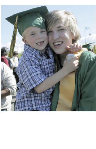 Kentridge High School senior Brandon Smith shares a hug Saturday with his younger brother Keaton outside the Tacoma Dome