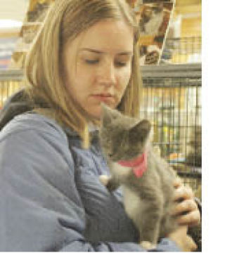 Katie Burke of Des Moines adopts a kitten at last year’s Adopt-a-Thon event in October.