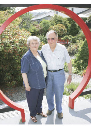 Kent residents Richard and Stella Land have been chosen by the Kent Historical Society as the Old Timers king and queen of Cornucopia Days. They have been married for 60 years and have lived in Kent for more than 40 years. They pose in their garden Wednesday.
