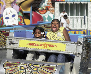 Two girls (names not given) react as the “Scrambler” speeds up during last year’s opening day for the Funtastic Rides carnival at Kent Cornucopia Days.