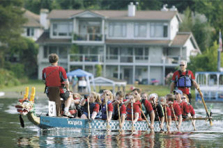 A dragon boat team competes on Lake Meridian during last year’s Kent Cornucopia Days Dragon Boat Races. This year