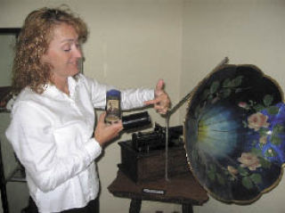 Kent Historical Museum Curator Linda Wagner shows off the cylindrical predecessor to the record from an early Thomas Edison phonograph.