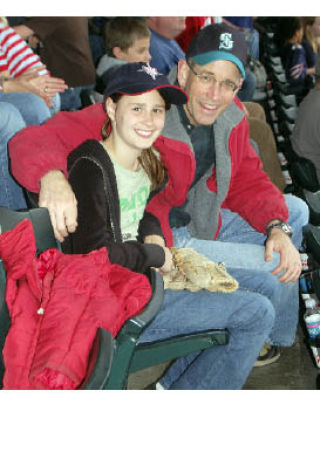 An unidentified fifth-grader and father watch a Tacoma Rainiers baseball game this spring. Part of the Rainiers All-Star Student Program
