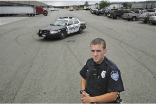Kent Police Officer Randy Brennan stands at the site where police arrested more than 100 people for illegal street racing in a private lot at 20300  59th Pl. S.