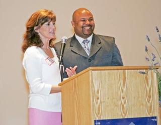 Motivational speaker and former NFL player Richard Thomas is introduced at a fundraising breakfast Friday by Kent Councilwoman Elizabeth Albertson. The breakfast was to support the Communities in Schools of Kent