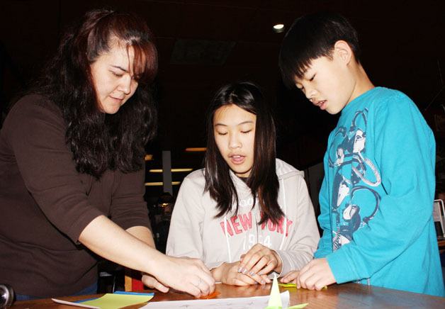 Emiko Knowlton helps Mariya Manuel