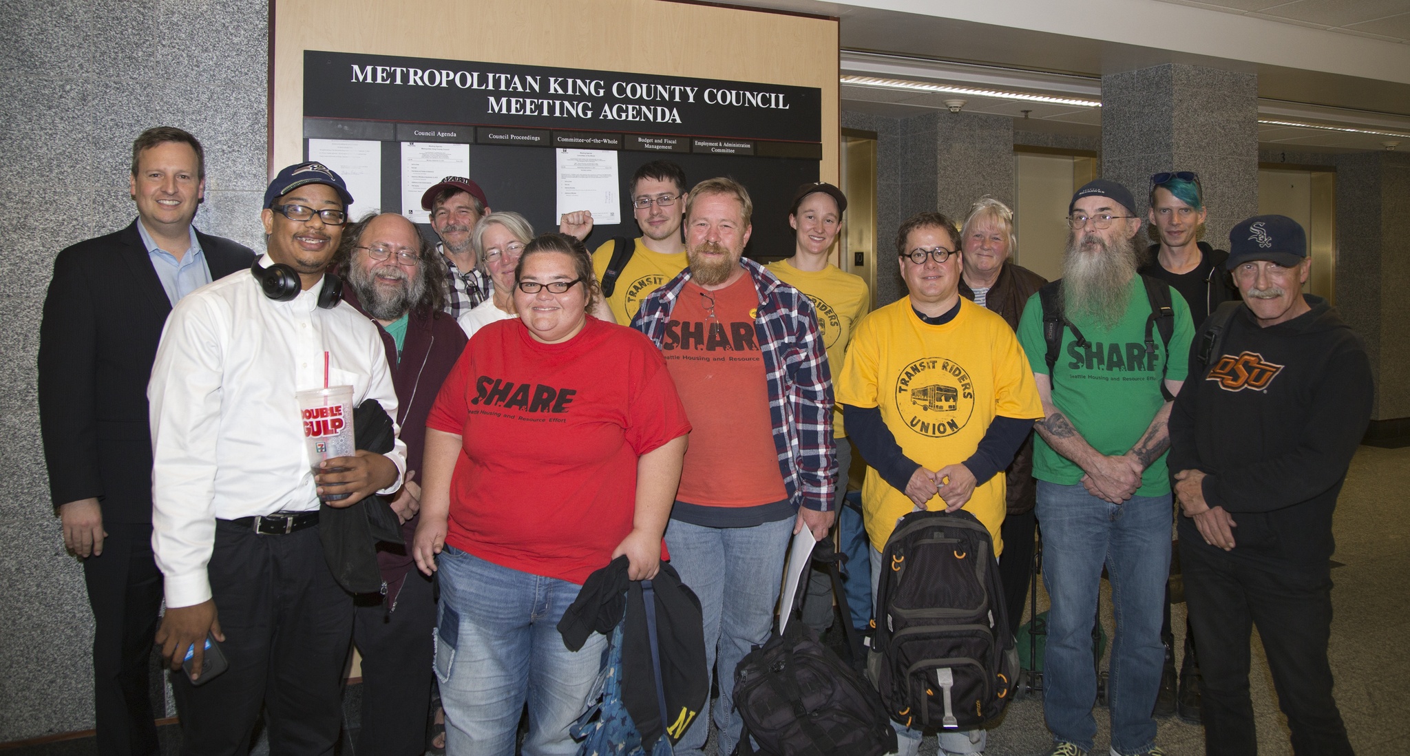King County Councilmember Dave Upthegrove (back row far left) with members of the Transit Riders Union after the County Council gave its unanimous support to expanding the King County Metro human services bus ticket program.