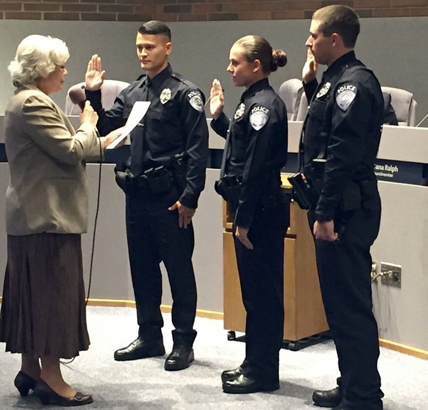 Mayor Suzette Cooke swears in Kent’s newest police officers during the Sept. 20 City Council meeting. Officers Ian Lentz (far left)
