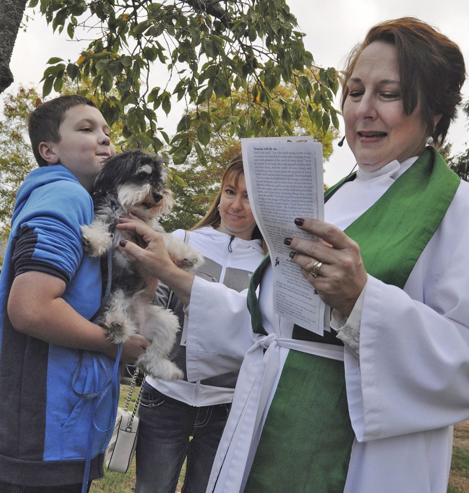 The Rev. Joyce Parry Moore blesses Cole Naccarato’s dog