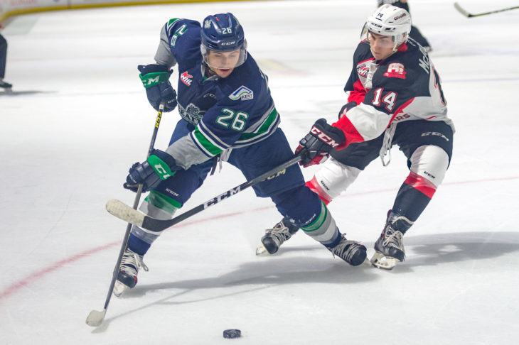 The Thunderbirds’ Nolan Volvan and the Cougars’ battle for the puck during WHL action Friday night at the ShoWare Center. COURTESY PHOTO