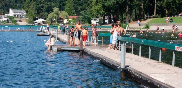 Swimmers walk the Lake Meridian Park dock. File Photo