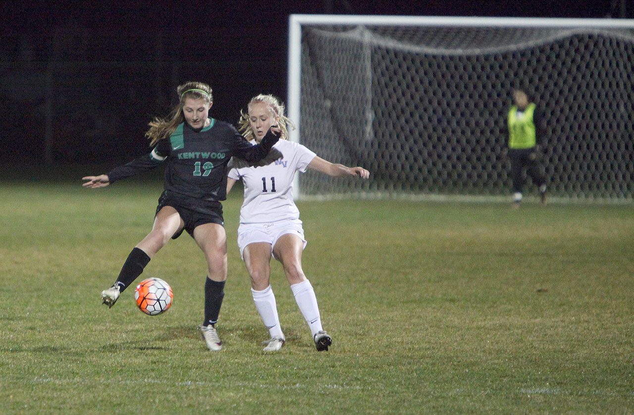 Kentwood High School junior Hailee Gabbard, left, works to keep the ball from West Valley High sophomore Jordan Karnes. Kentwood was eliminated from the first round of the 4A state soccer playoffs with a 1-0 loss to West Valley on Tuesday night in Yakima. COURTESY PHOTO, Tracy Arnold