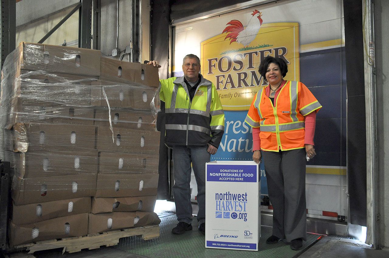 Jim Floreck, left, a driver for Foster Farms in Kelso, delivers five pallets loaded with 640 turkey to Northwest Harvest’sdistribution center in Kent. Floreck was joined by Gayle Johnson, chief external relations officer for Northwest Harvest.HEIDI SANDERS, Kent Reporter