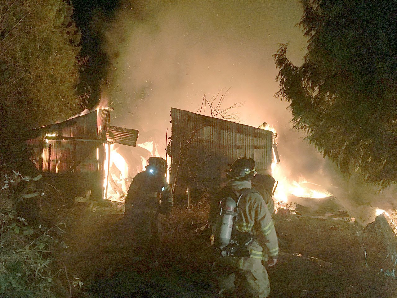 Firefighters battle a barn fire Sunday in the 14000 block of Southeast 283rd Place. Courtesy Photo, Kent RFA