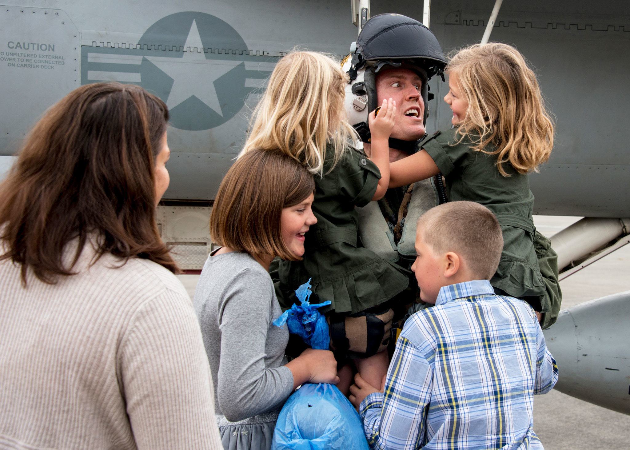 Navy pilot Daniel Cochran greets his children after returning from a mission. COURTESY PHOTO, U.S. Navy Petty Officer 3rd Class Matthew C. Duncker