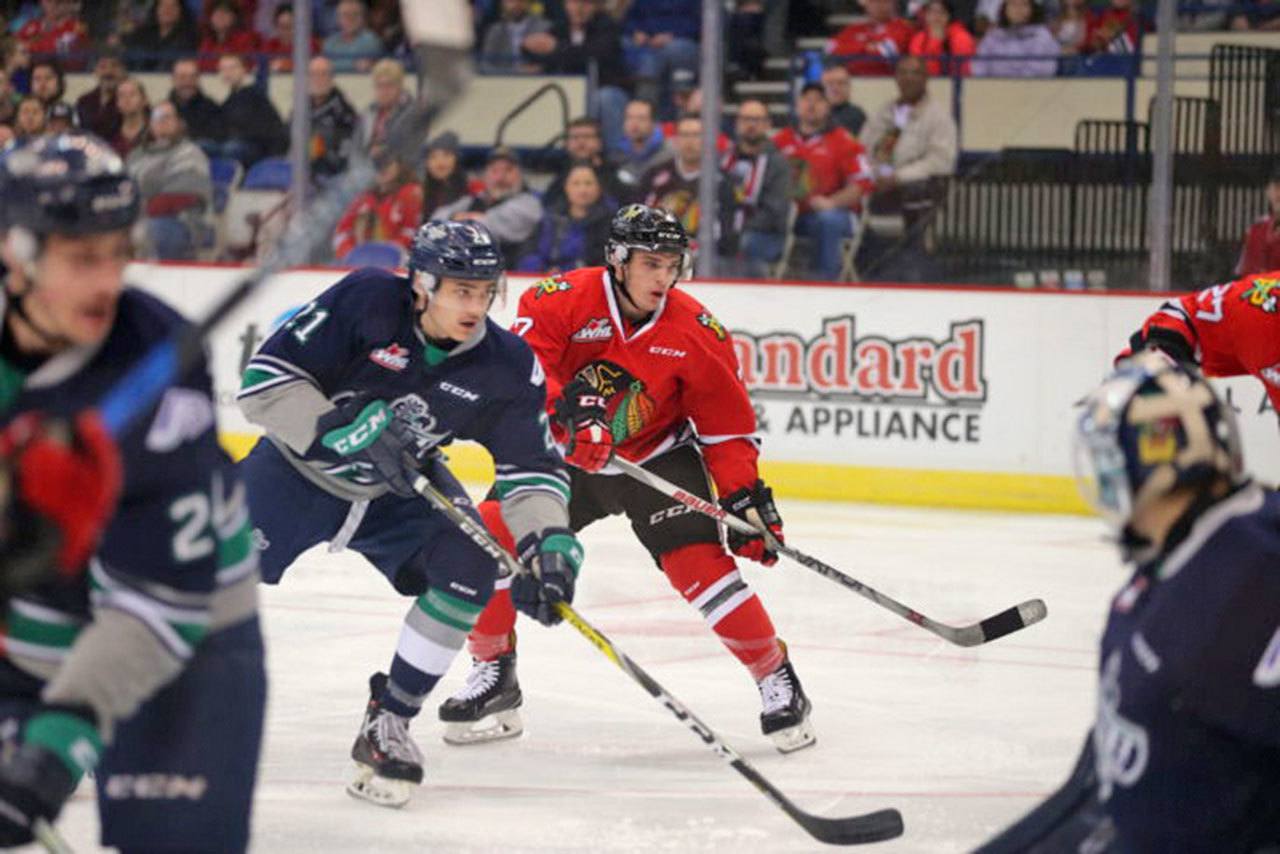 The Thunderbirds’ Matthew Wedman battles the Winterhawks in WHL play at Veterans Memorial Coliseum on Saturday night. COURTESY PHOTO