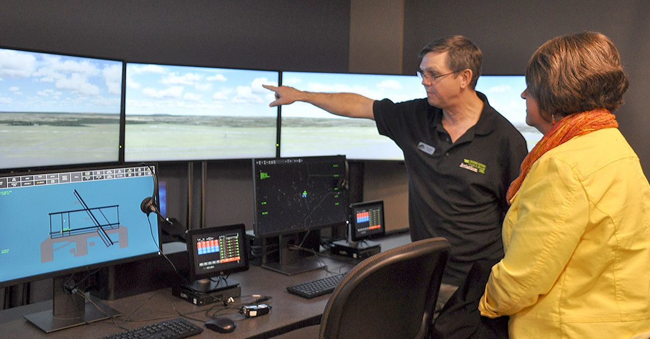 Jerry Wolfe, aviation faculty and bachelor’s degree program director at Green River College, points out features of an air traffic control tower simulator at the college’s new Auburn Center. HEIDI SANDERS, Kent Reporter