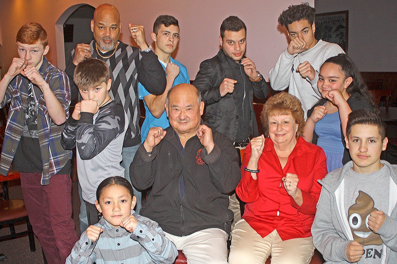 Glen and Leslie Hamada, center, with members of their boxing club, show fighting determination to make a difference in the community. MARK KLAAS,Kent Reporter