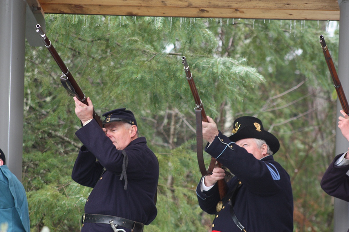Civil War re-enactors, the 4th U.S. Infantry, fire shots from a gun salute at the ceremony. MARK KLAAS, Kent Reporter