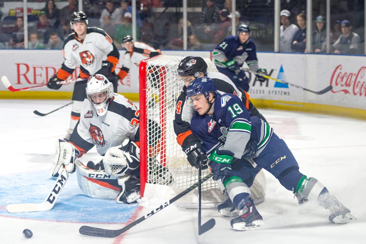 The Thunderbirds’ Donovan Neuls looks to circle around and fire a shot at Tigers goalie Duncan McGovern during WHL play Saturday night at the ShoWare Center. COURTESY PHOTO, Brian Liesse, Thunderbirds