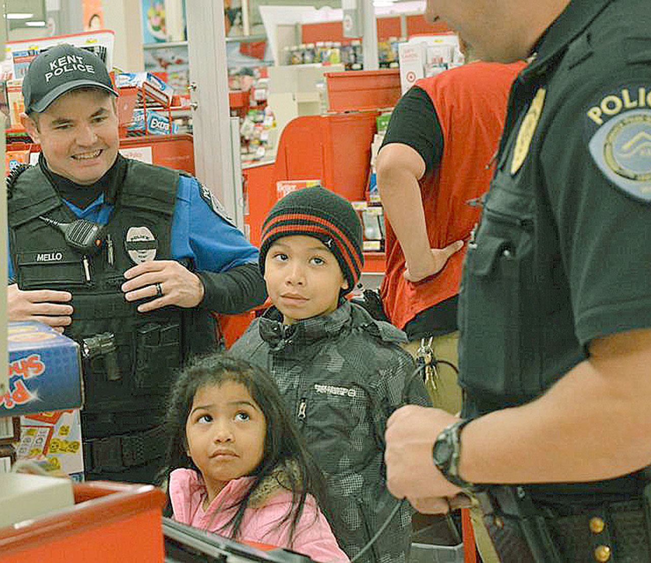 Kent Police officers help children shop for holiday gifts on Dec. 3 at Target.