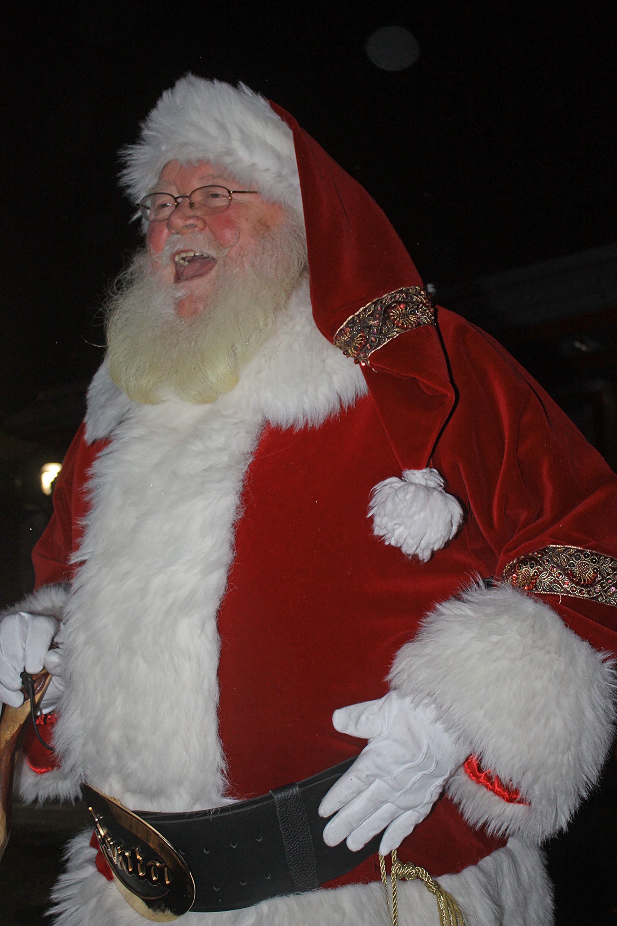 Santa Claus arrives by fire truck, greeting children and families during Winterfest at the Town Square Plaza on Saturday. MARK KLAAS, Kent Reporter
