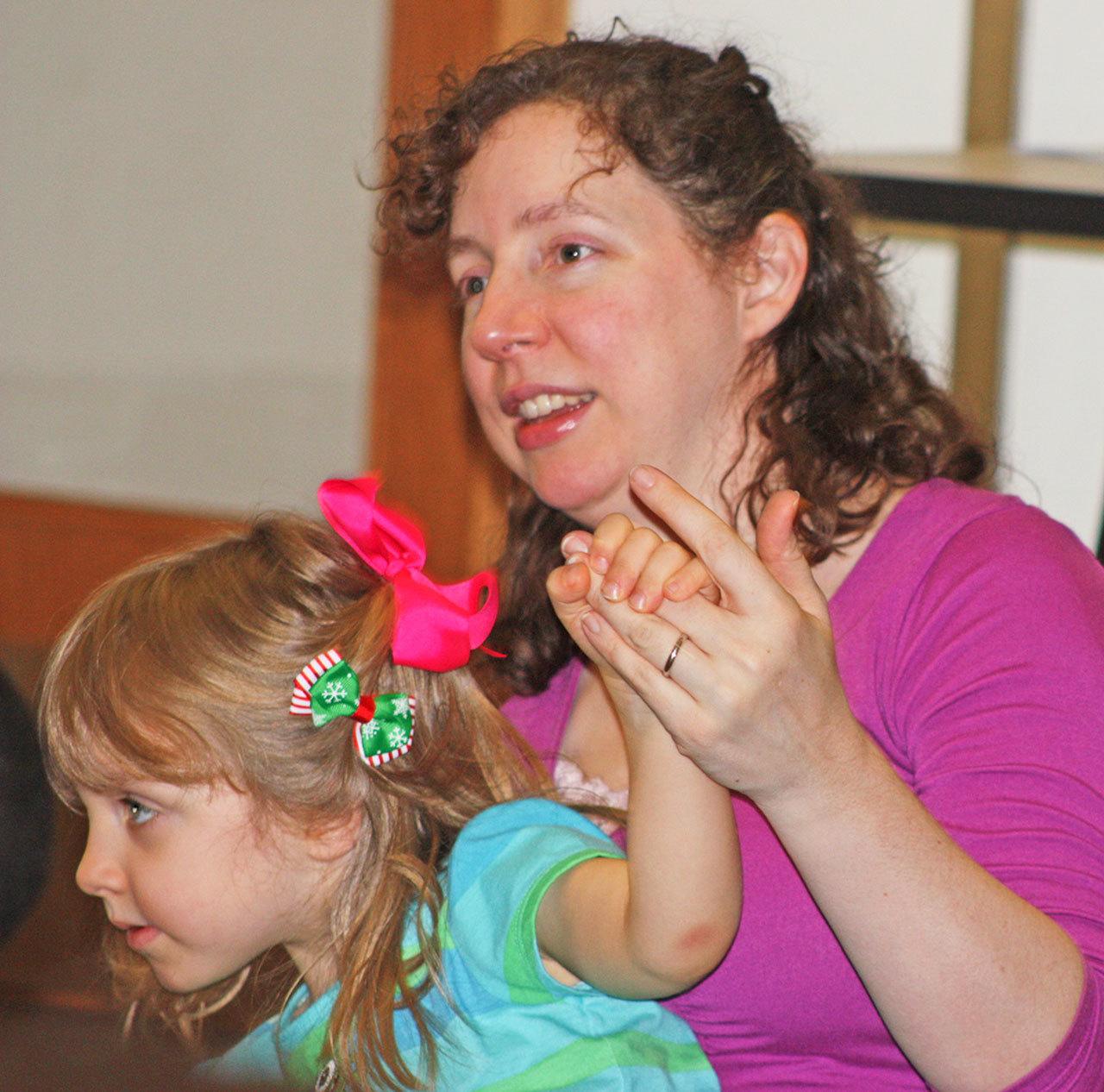 Tara Jaeger and her 3-year-old daughter, Fiona, swing to the music. MARK KLAAS, Kent Reporter