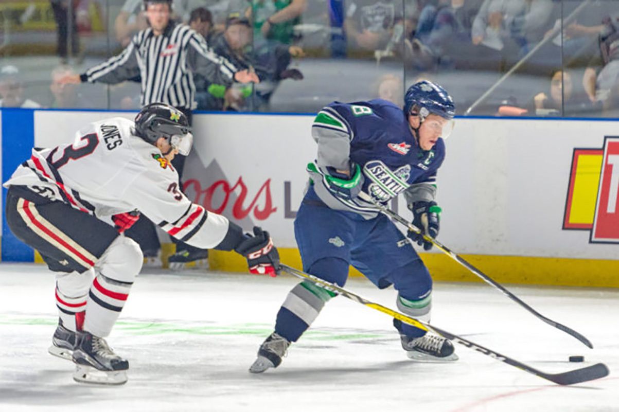 The Thunderbirds’ Scott Eansor, right, and the Winterhawks’ Caleb Jones pursue the puck during WHL play. COURTESY PHOTO, Brian Liesse/T-Birds