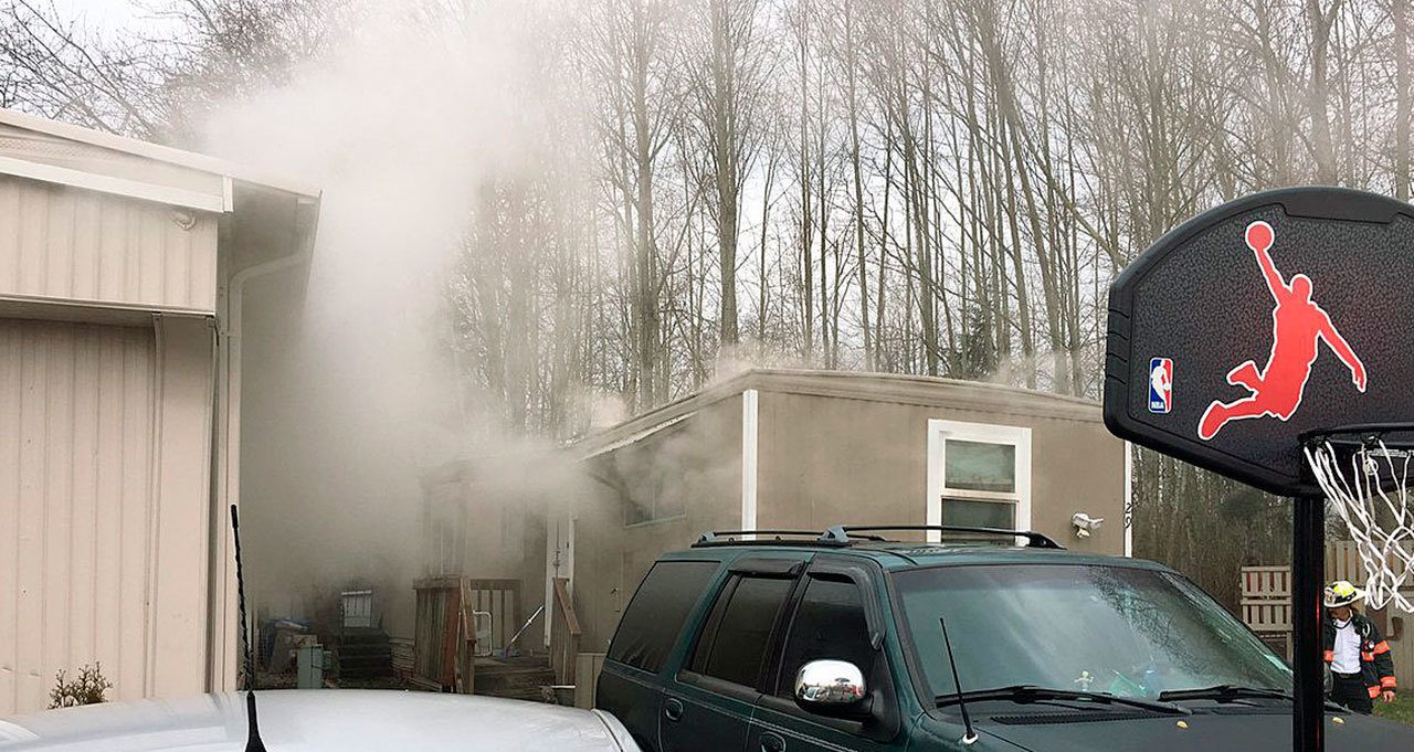 Firefighters extinguish a mobile home fire Tuesday in the 800 block of the West Valley Highway. Courtesy Photo/Puget Sound RFA