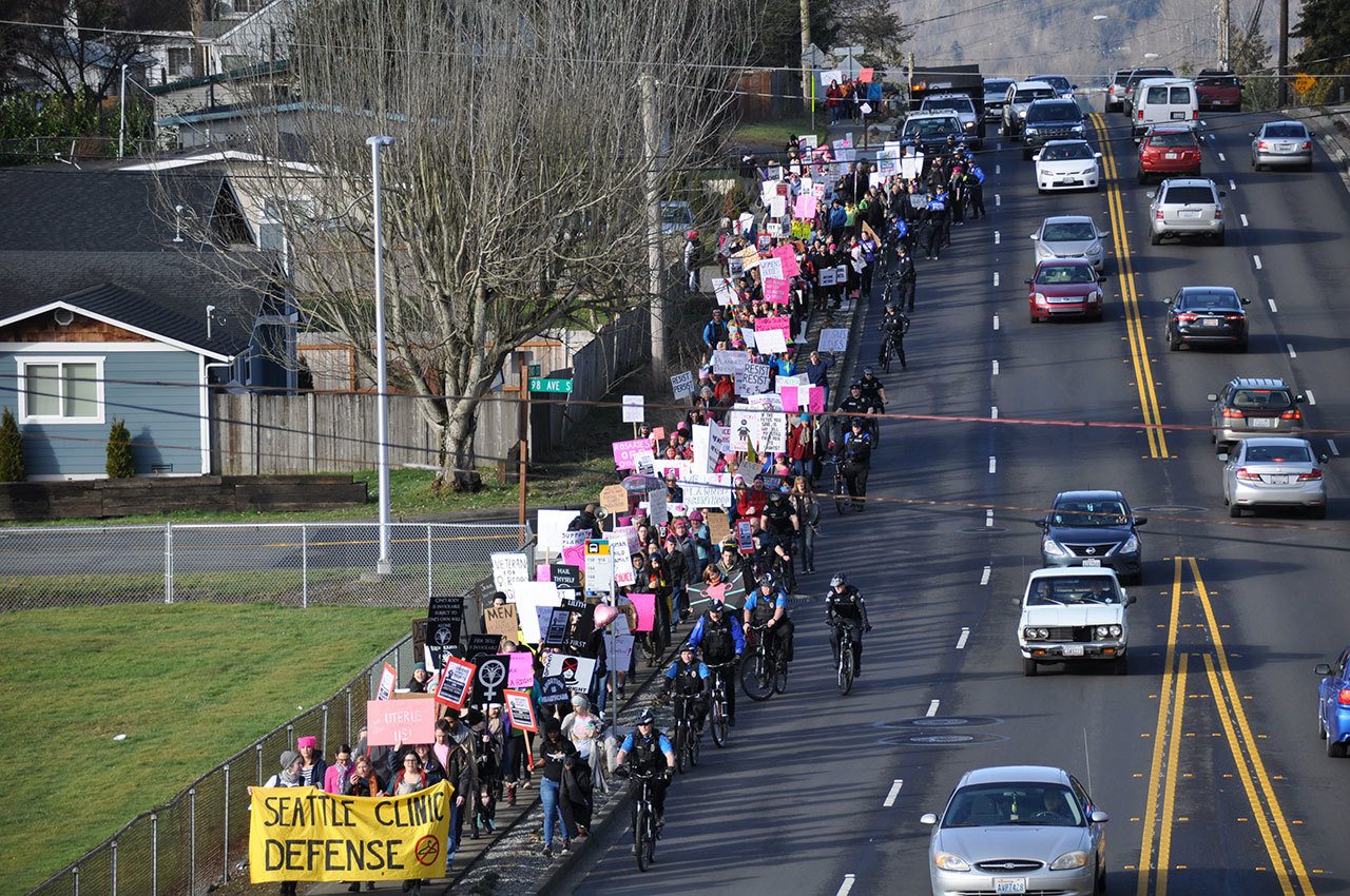 Hundreds of Planned Parenthood supporters make their way up the James/240th Street Hill on Saturday in response to calls to defund the organization. HEIDI SANDERS, Kent Reporter