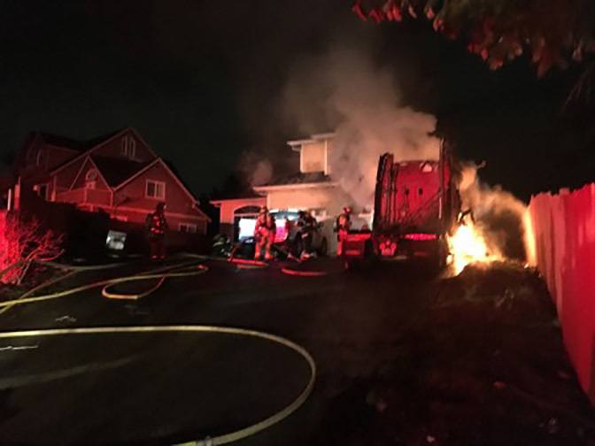 Firefighters from Puget Sound Fire and several other departments quickly extinguished a house fire that was sparked by a parked semi-truck Sunday night. COURTESY PHOTO, Puget Sound Fire