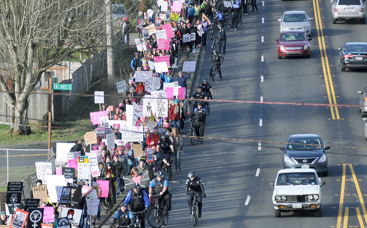 Police officers from Kent and other cities that are part of the Valley Civil Disturance Unit move up the James Street/240th Hill last Saturday during a Planned Parenthood rally.