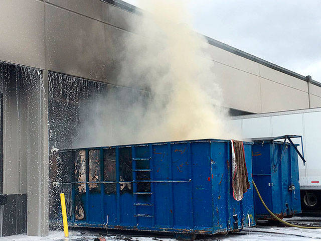 Kent firefighters extinguish dumpster fire next to commerical building