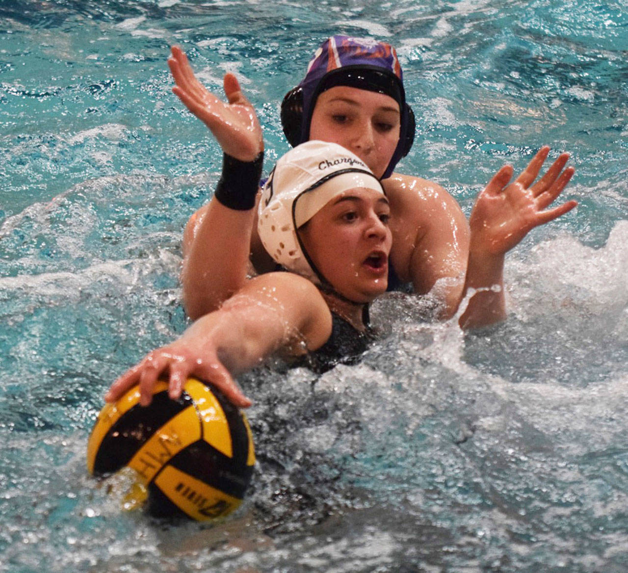 Kentridge’s Sam Gilman (3) works with the ball as Auburn Mountainview’s Janeese Singer defends during water polo action Thursday. RACHEL CIAMPI, Kent Reporter