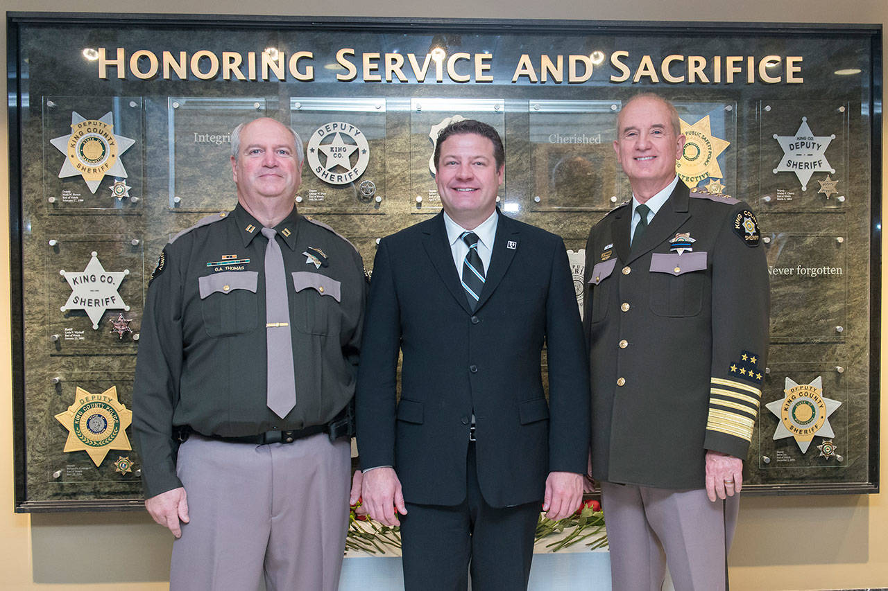 King County Councilmember Reagan Dunn, middle, joins Major Greg Thomas, left, and Sheriff John Urquhart, right, in front of the King County Sheriff’s Officer Memorial. COURTESY PHOTO