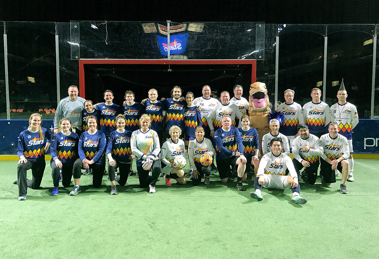 Stars come out: The Kent Downtown Partnership formed two teams, the Raptors and Asteroids, for a soccer friendly at the ShoWare Center prior to the Tacoma Stars game last Friday. COURTESY PHOTO