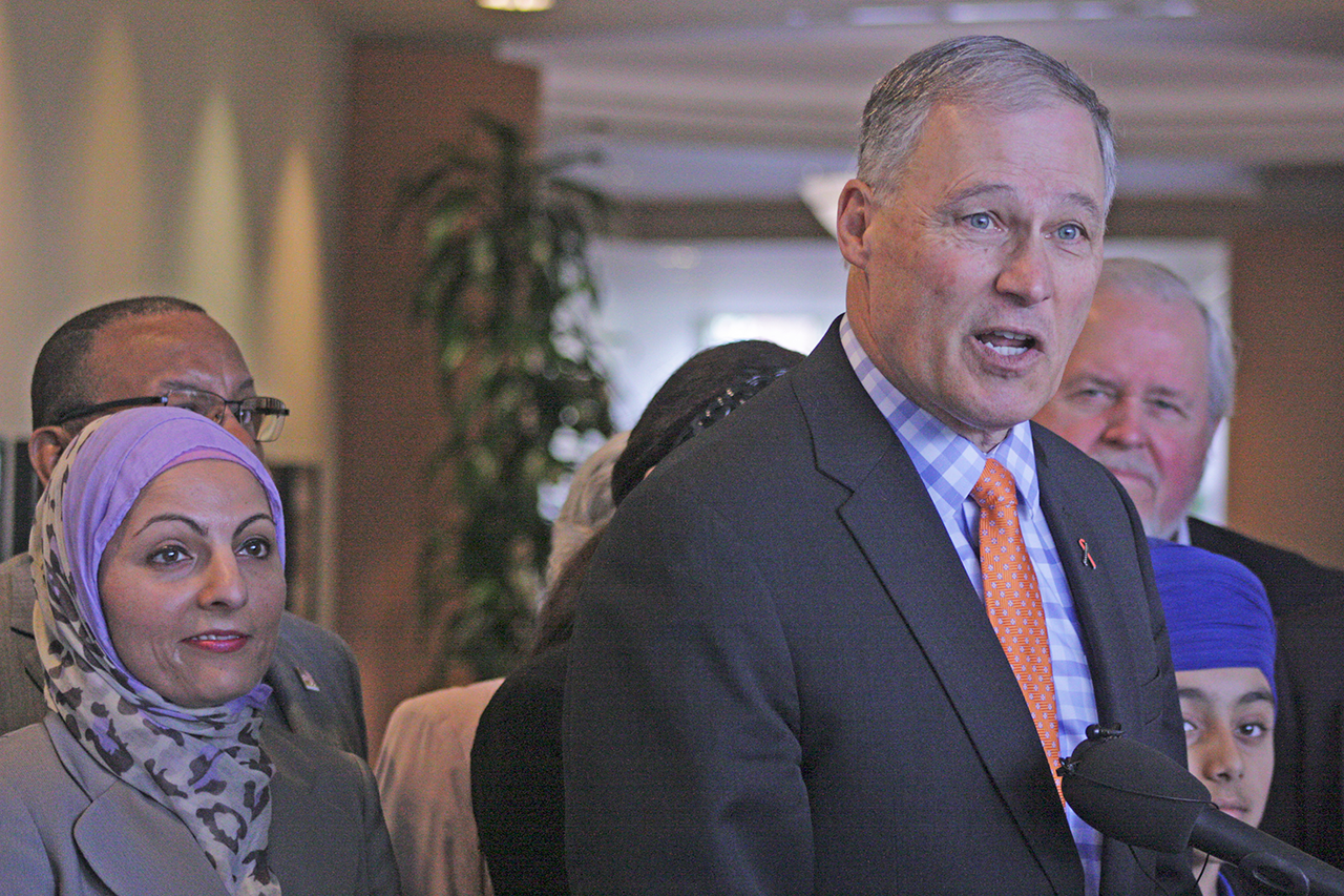 Gov. Jay Inslee joins interfaith and neighborhood leaders for an impromptu news conference at Kent’s Centennial Center on Thursday. Inslee visited Kent for a roundtable discussion on hate crimes. MARK KLAAS, Kent Reporter