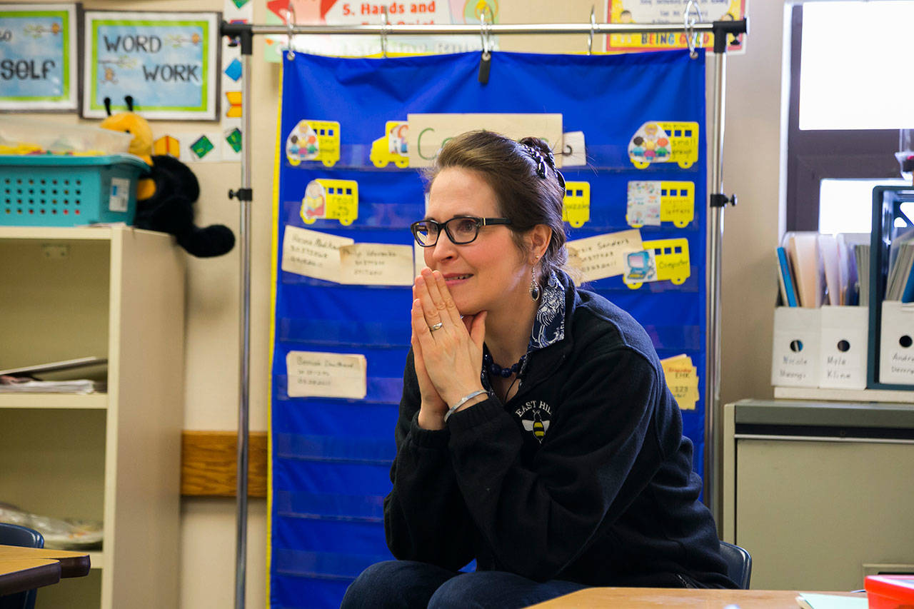 Smile Maker Joan Johnson observes the classroom as the Delta Dental of Washington Tooth Fairy reveals she has a special surprise. COURTESY, VanHouten Photography