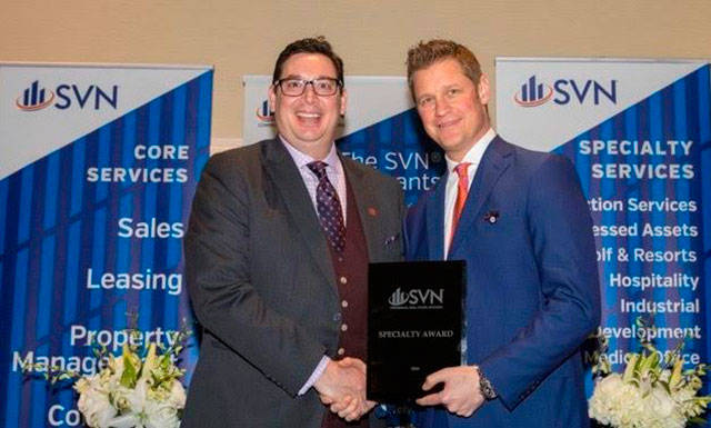 Chad Gleason, left, receives the 2017 Team Player of the Year award at the SVN National Conference. COURTESY PHOTO