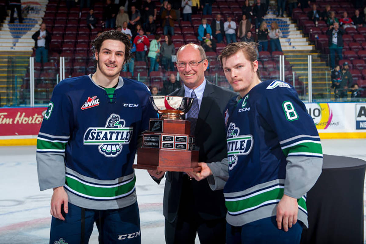 The Thunderbirds’ Mathew Barzal (13) and Scott Eansor (8) join Richard Doerksen, vice president of hockey for the WHL, at center ice with the Western Conference Championship Cup Sunday at Prospera Place in Kelowna, British Columbia. COURTEST PHOTO, Marissa Baecker/Shoot the Breeze