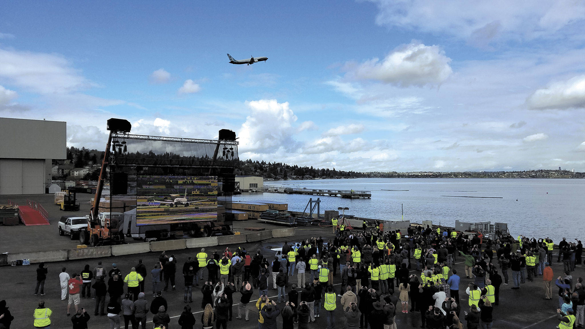 Employees at Boeing Renton watch as the 737 MAX 9 takes to the skies above Lake Washington for its first flight.